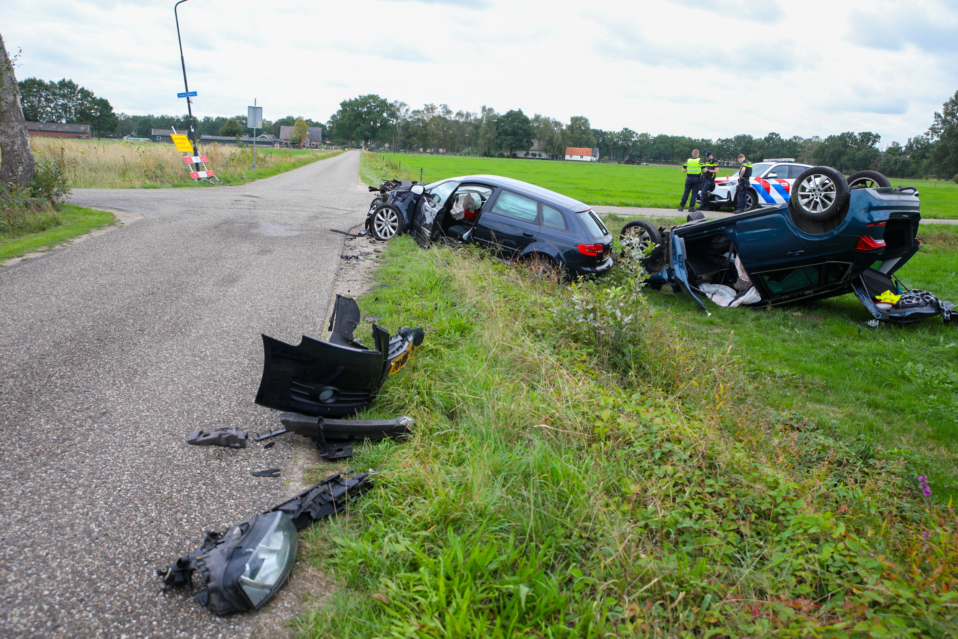 Zware botsing in Klarenbeek auto op de kop in weiland twee gewonden